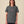 T-shirt BUMA X BRAGHE colore Antracite vista da davanti, con piccola stampa rosa BUMA X BRAGHE al centro del petto