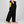 Pantaloni CEREDO Limited Edition vista laterale, neri con tasca gialla